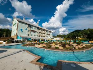 a hotel with a swimming pool in front of a building at The Lodge at Camp Margaritaville in Pigeon Forge