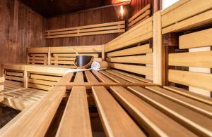 an empty sauna with wooden benches and aperature at Leonardo Royal Hotel Frankfurt in Frankfurt