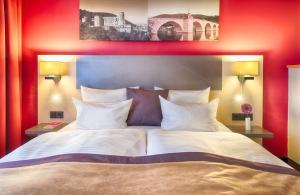 Postel nebo postele na pokoji v ubytování Leonardo Hotel Heidelberg