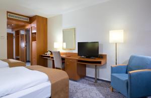 TV a/nebo společenská místnost v ubytování Leonardo Hotel Heidelberg