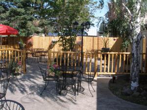 a patio with tables and chairs and a fence at Eagle Rock Resort in Naches
