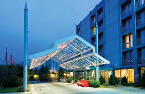 a building with lights on the side of it at Leonardo Hotel Hannover Airport in Hannover