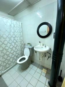 a bathroom with a toilet and a sink at The Nest - Cozy 3-Bedroom Condo with Pool in Shah Alam