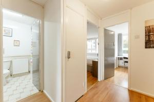 a hallway with a glass door leading to a bedroom at Langdon Park DLR beds to stay in London