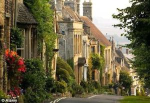 a street in a town with houses on the side at Charming Victorian Townhouse Near Oxford in Witney