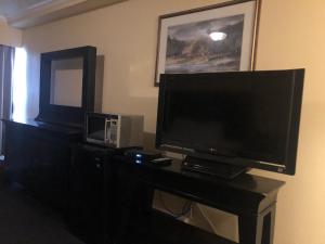 a flat screen tv sitting on top of a dresser at Island Travel Inn in Victoria