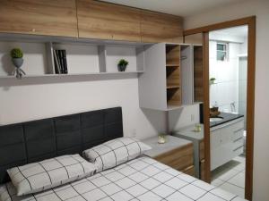 a small bedroom with a bed and a kitchen at Apartamento em Nova Betânia - West Flat Mossoró in Mossoró