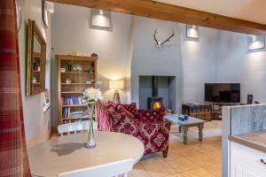 a living room with a couch and a table at Waterside Cottage in Harrogate