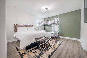 a bedroom with a large bed and a mirror at New Construction Located in Ybor City! in Tampa