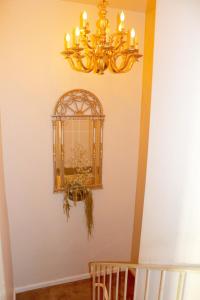 una lámpara de araña colgada en una pared junto a una escalera en Shared Home, en Inglewood