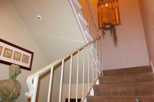 a staircase in a home with a chandelier at Shared Home in Inglewood