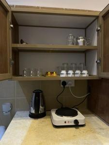 a toaster sitting on a counter in a kitchen at سويت روز العلا للشقق المفروشة sweet rose al ula organizing tours in AlUla