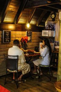a man and woman sitting at a table in a restaurant at Pousada Rancho Alvorada in Praia Grande +63 photos