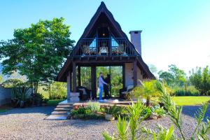 a man standing in a gazebo in a garden at Pousada Rancho Alvorada in Praia Grande