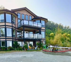 a large building with balconies and tables in front of it at Executive pet friendly lower suite with ocean view in Ladysmith