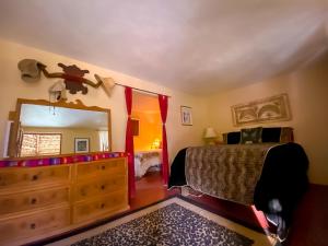 a bedroom with a bed and a dresser and a mirror at Rancho Parralito 