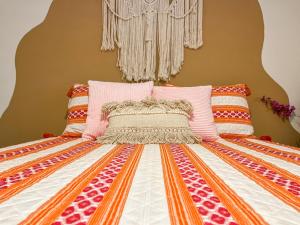 a bed with a comforter and pillows on it at Casa Del Sol in Phoenix