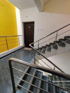 an empty room with stairs and a door at Allamanda Abode in Chennai