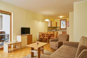 a living room with a couch and a table at Thermal Apartments Lendava in Lendava