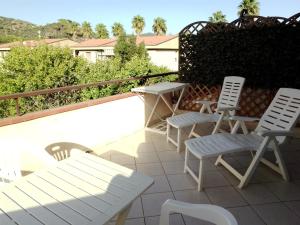 two chairs and a table and two chairs on a patio at La Casa di Berenice a Porto Azzurro in Porto Azzurro