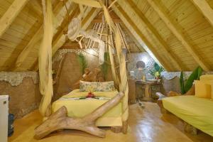 a bedroom with a canopy bed in a room at CHALET TROPICAL bio-hotel in Las Galeras