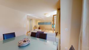 a living room with a dining table and a couch at Chesa Seraina Abitaziun Seraina 7 - Chamois in Madulain