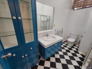 a bathroom with a blue sink and a toilet at Solok Burma Vacation Home @ Gurney Penang in George Town +60 photos