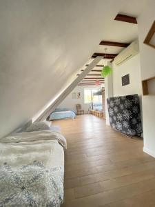 a attic bedroom with a bed and a staircase at Maison familiale 152m2 à 10 minutes de Colmar in Wintzenheim