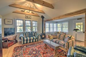 a living room with two couches and a fireplace at Wild Goose Cottage on Little Lake Sunapee! in New London