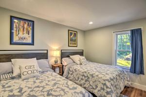 a bedroom with two beds and a window at Wild Goose Cottage on Little Lake Sunapee! in New London