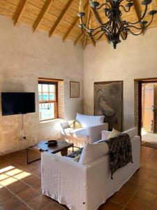 a living room with a couch and a tv at Barrel House Suite St Eustatius in Oranjestad