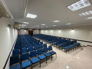 an empty room with blue chairs in a building at Rede Andrade Aquarius in Porto Velho +33 photos