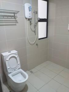 a bathroom with a shower and a toilet in it at Labuan Paragon Apartment - 3 rooms in Labuan