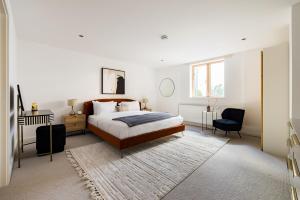 a bedroom with a bed and a desk and a chair at The Clapham Dream - Captivating 3BDR with Garden & Parking in London