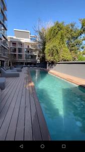 a swimming pool on a wooden deck in a building at 304 San Lorenzo in Mar del Plata