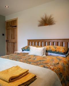 a bedroom with a bed with towels on it at Coorie View in Kilmore