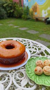 una mesa con un pastel y un plato de galletas en Pousada Lira Praieira Paraty, en Paraty