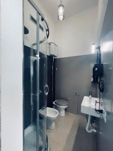 a bathroom with a shower and a toilet and a sink at B&B Ungheria Ottantaquattro in Palermo
