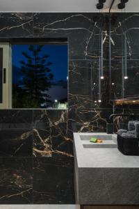 a bathroom with a black marble wall at Urban Lofts in Chania