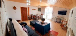 a living room with a couch and a table at casa rural La Plazuela de Mari in Pereña