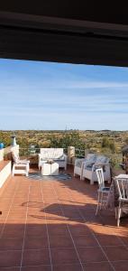 a patio with couches and chairs on a roof at casa rural La Plazuela de Mari in Pereña