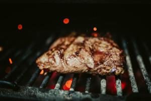 a piece of meat cooking on a grill at Gran Hotel Don Manuel in Cáceres