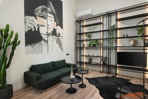 a living room with a green couch and a painting at Urban Lofts in Chania
