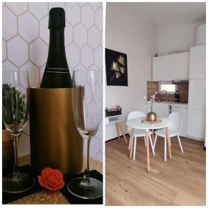 - une bouteille de vin et une coupe de champagne dans le salon dans l'établissement Suite romantique avec sauna et balnéo privatifs au Barcarès, au Barcarès