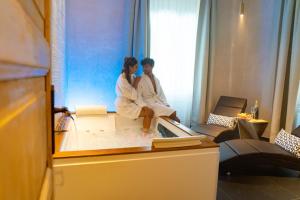 a man and a woman sitting in a bath tub at Villa Ghiron in Torriglia