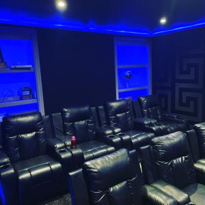 a room with black leather chairs and blue lights at Catchdale Moss Cottage 