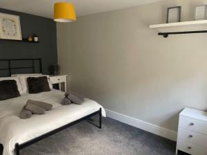 a bedroom with a bed and a dresser at Maple House 2 bed House with free parking in town by ShortStays4U in King's Lynn