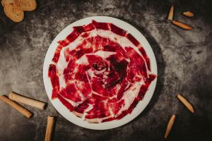a plate of red food on a table at Gran Hotel Don Manuel in Cáceres