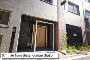 una entrada a un edificio con una puerta marrón en MONday Apart 日本橋水天宮前 en Tokio