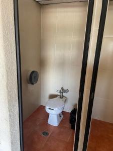 a bathroom with a toilet in a stall at Hotel Lerma in Lerma de Villada
